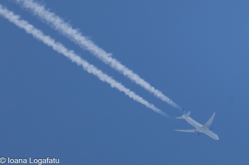 Aircraft leaving trails in the bright blue sky